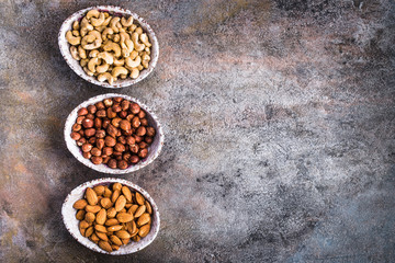 Shelled hazelnuts almonds and cashew above