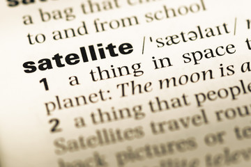 Fototapeta premium Close up of old English dictionary page with word satellite