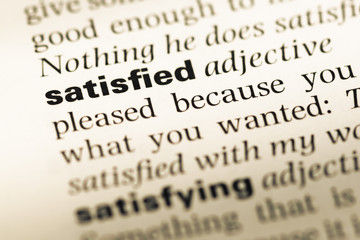 Fototapeta premium Close up of old English dictionary page with word satisfied