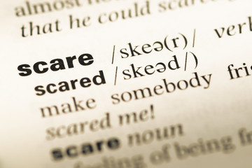 Close up of old English dictionary page with word scare