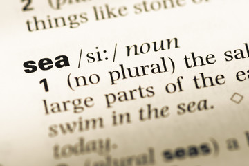 Fototapeta premium Close up of old English dictionary page with word sea