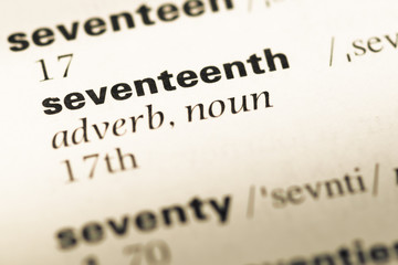 Close up of old English dictionary page with word seventeenth
