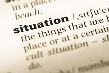 Obraz premium Close up of old English dictionary page with word situation