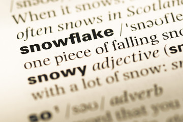 Fototapeta premium Close up of old English dictionary page with word snowflake
