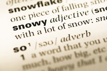 Fototapeta premium Close up of old English dictionary page with word snowy