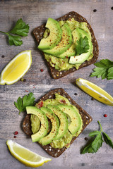 Delicious wholewheat toast with guacamole and avocado slices. © lilechka75