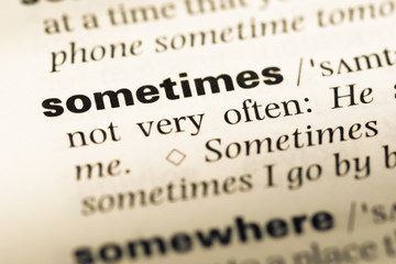 Close up of old English dictionary page with word sometimes