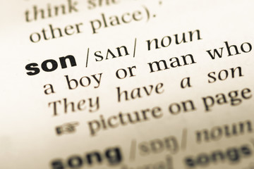 Obraz premium Close up of old English dictionary page with word son