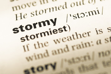 Fototapeta premium Close up of old English dictionary page with word stormy