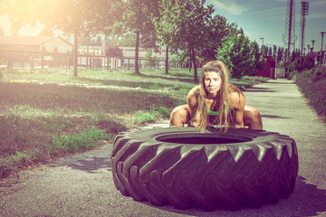 Girl flipping tire during exercise