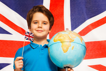 Boy with flag and globe in front of British banner