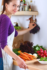 Young woman cutting vegetables in the kitchen