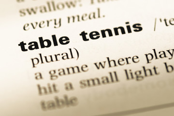 Close up of old English dictionary page with word table tennis
