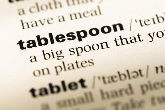 Close up of old English dictionary page with word tablespoon