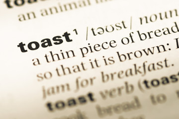 Close up of old English dictionary page with word toast