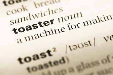 Close up of old English dictionary page with word toaster