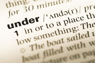 Close up of old English dictionary page with word under