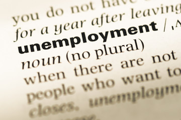 Fototapeta premium Close up of old English dictionary page with word unemployment