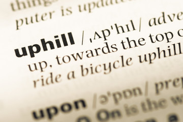 Close up of old English dictionary page with word uphill