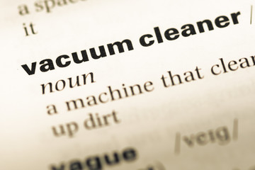 Close up of old English dictionary page with word vacuum cleaner