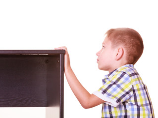 Bored little boy sit alone at table.