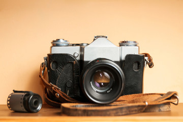 Vintage Camera with old photographs and films on a wooden table