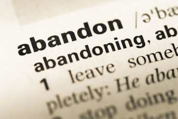 Fototapeta premium Close up of old English dictionary page with word abandon