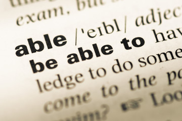 Obraz premium Close up of old English dictionary page with word able