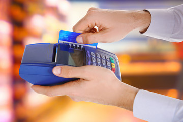 Credit card payment. Businessman using payment terminal