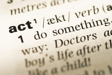 Obraz premium Close up of old English dictionary page with word act