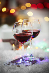 Two glasses of red wine on Christmas decoration background