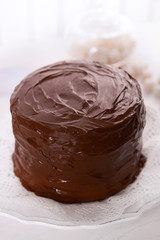 Tasty chocolate cake on light background