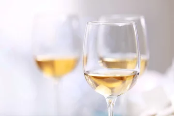 Fototapeten Wineglasses on light blurred background © Africa Studio