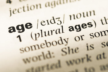 Obraz premium Close up of old English dictionary page with word age