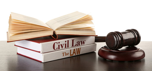 Gavel and books on wooden table on white background