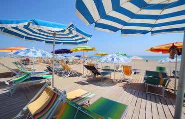shade of the umbrellas on the beach of the tourist village by th