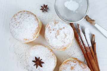 Fototapeta na wymiar Fresh homemade donuts with powdered sugar, close up