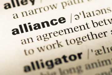 Obraz premium Close up of old English dictionary page with word alliance