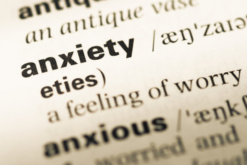 Fototapeta premium Close up of old English dictionary page with word anxiety