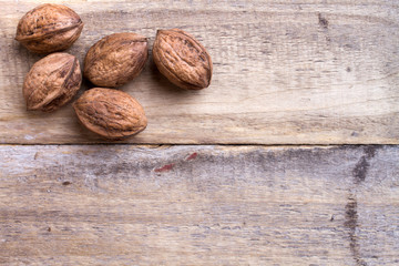 five walnuts on wooden table