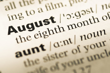 Obraz premium Close up of old English dictionary page with word August