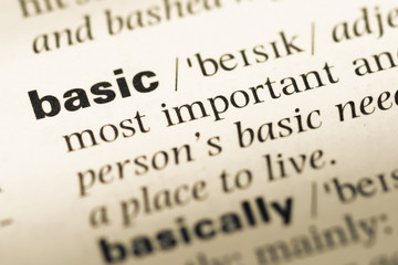 Close up of old English dictionary page with word basic