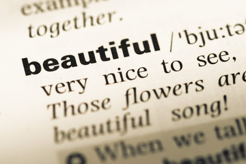 Close up of old English dictionary page with word beautiful