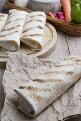 burrito on parchment with vegetables