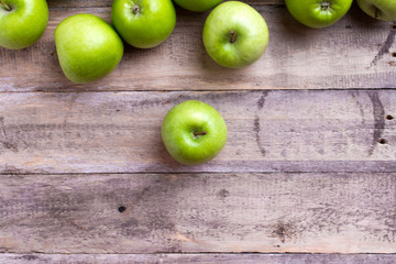 green apples on wood