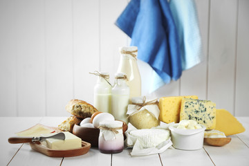 Set of fresh dairy products on white wooden table