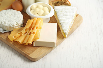 Set of fresh dairy products on white wooden table