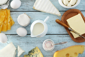 Set of fresh dairy products on blue wooden table, close up