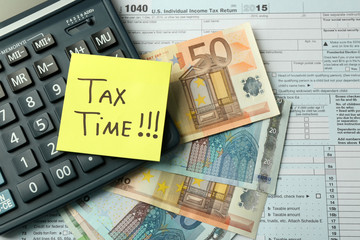 Money concept. Black calculator with cash and documents, close up