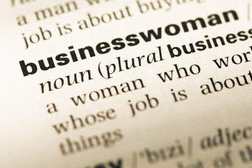 Close up of old English dictionary page with word businesswoman